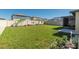 Well-manicured backyard featuring a lush lawn, privacy fence, and tropical landscaping elements at 22111 Nebula Way, Land O Lakes, FL 34637