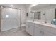 Stylish bathroom features double vanity with quartz countertop and a glass enclosed shower at 22111 Nebula Way, Land O Lakes, FL 34637
