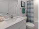 Bathroom featuring a shower/tub combo, bright lighting, and a stylish vanity at 22111 Nebula Way, Land O Lakes, FL 34637