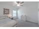 Cozy bedroom features a window for natural light, carpet flooring, and a ceiling fan at 22111 Nebula Way, Land O Lakes, FL 34637