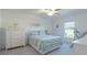 Bright bedroom features a ceiling fan, carpet flooring, and a large window providing natural light at 22111 Nebula Way, Land O Lakes, FL 34637