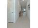 Inviting hallway with light ceramic tile flooring and neutral paint at 22111 Nebula Way, Land O Lakes, FL 34637