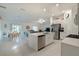 Open-concept kitchen featuring stainless steel appliances and island with sink at 22111 Nebula Way, Land O Lakes, FL 34637