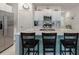 Bright kitchen features island with seating, modern appliances and white cabinetry at 22111 Nebula Way, Land O Lakes, FL 34637