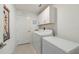Well-organized laundry room with modern appliances and ample storage space at 22111 Nebula Way, Land O Lakes, FL 34637