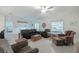 Bright and airy living room with neutral tones, ceiling fan, and sliding glass doors at 22111 Nebula Way, Land O Lakes, FL 34637
