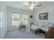 Bright living room offering natural light, a ceiling fan, and comfortable seating at 22111 Nebula Way, Land O Lakes, FL 34637