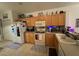 Well-equipped kitchen featuring wood cabinetry, a practical layout, and modern appliances, enhancing the home's appeal and functionality at 227 Golden Harbour Trail Way, Bradenton, FL 34212