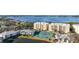 Aerial view showing a residential complex with tennis courts and scenic waterfront vistas on a clear, sunny day at 280 Hidden Bay Dr # 202, Osprey, FL 34229