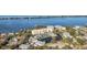 Aerial shot of residential buildings with tennis courts and a pond, set against a serene waterfront backdrop at 280 Hidden Bay Dr # 202, Osprey, FL 34229