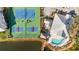 Aerial view of community amenities featuring tennis courts, pickleball, pool, tiki bar, and lake at 280 Hidden Bay Dr # 202, Osprey, FL 34229