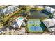 Aerial view of community pool, tennis, pickleball courts, and pond with walking bridge at 280 Hidden Bay Dr # 202, Osprey, FL 34229