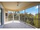 This screened-in balcony features lovely tree-top views, tiled floors, and a ceiling fan for optimal comfort at 280 Hidden Bay Dr # 202, Osprey, FL 34229