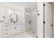 Bathroom with double vanity, marble countertop, modern fixtures, and a glass-enclosed shower at 280 Hidden Bay Dr # 202, Osprey, FL 34229