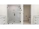 Bathroom featuring glass-enclosed shower with white tile, adjacent to toilet and vanity areas at 280 Hidden Bay Dr # 202, Osprey, FL 34229