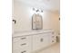 Bathroom featuring a double vanity, marble countertop, modern light fixture and black hardware at 280 Hidden Bay Dr # 202, Osprey, FL 34229