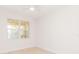 Bright bedroom with light wood floors and a large window with a view at 280 Hidden Bay Dr # 202, Osprey, FL 34229