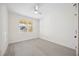 Bright bedroom featuring ceiling fan, large window, and light wood floors at 280 Hidden Bay Dr # 202, Osprey, FL 34229