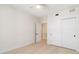 Bright bedroom with ceiling fan, light wood floors, and large sliding door closet at 280 Hidden Bay Dr # 202, Osprey, FL 34229