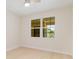 Bright bedroom with light wood floors and a large window with a view at 280 Hidden Bay Dr # 202, Osprey, FL 34229