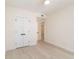 Bedroom featuring light hardwood floors, white trim, and a closet with pair of white doors with black hardware at 280 Hidden Bay Dr # 202, Osprey, FL 34229