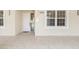 Inviting entrance with a white front door, natural lighting, and clean, neutral tones at 280 Hidden Bay Dr # 202, Osprey, FL 34229