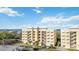 Beautiful exterior of a condo complex with bright paint, open-air walkways, and well-maintained landscaping at 280 Hidden Bay Dr # 202, Osprey, FL 34229