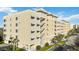 Beautiful exterior of a condo complex with bright paint, open-air walkways, and well-maintained landscaping at 280 Hidden Bay Dr # 202, Osprey, FL 34229