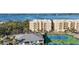 Exterior shot showcasing a multi-unit residential building with tennis courts, surrounded by lush landscaping and water views at 280 Hidden Bay Dr # 202, Osprey, FL 34229
