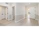 Bright hallway featuring white trim, light wood floors, and multiple doorways at 280 Hidden Bay Dr # 202, Osprey, FL 34229
