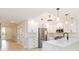 Modern kitchen with a stainless steel refrigerator, white cabinets, and a kitchen island at 280 Hidden Bay Dr # 202, Osprey, FL 34229
