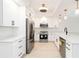 Modern kitchen with stainless steel appliances, quartz countertops, and white cabinetry at 280 Hidden Bay Dr # 202, Osprey, FL 34229
