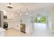 Open-concept kitchen featuring stainless steel appliances, white cabinetry, and a view of the balcony at 280 Hidden Bay Dr # 202, Osprey, FL 34229