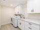 Spacious laundry room with a sink, plenty of counter space, and a washer and dryer at 280 Hidden Bay Dr # 202, Osprey, FL 34229