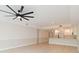Bright living room featuring white cabinets and flooring, and modern ceiling fan at 280 Hidden Bay Dr # 202, Osprey, FL 34229