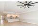Open living room with kitchen, a large ceiling fan, and bright, airy layout at 280 Hidden Bay Dr # 202, Osprey, FL 34229