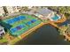 Overhead view of tennis courts, pool, and waterfront gazebo, highlighting the community's recreational amenities at 280 Hidden Bay Dr # 202, Osprey, FL 34229