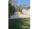 Backyard area with a gravel patio area with outdoor seating. and surrounding landscaping at 3013 Yarmouth W Dr, Bradenton, FL 34205