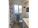 Bathroom featuring a tiled floor, toilet, patterned shower curtain, and a vanity with a white countertop at 3013 Yarmouth W Dr, Bradenton, FL 34205