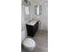 Compact bathroom with a dark vanity and modern fixtures at 3013 Yarmouth W Dr, Bradenton, FL 34205