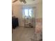 Bedroom featuring wood-look flooring, neutral walls and a window at 3013 Yarmouth W Dr, Bradenton, FL 34205