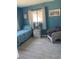 Well-lit bedroom featuring a comfortable bed, a nightstand with a lamp, and an armchair at 3013 Yarmouth W Dr, Bradenton, FL 34205