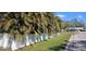 Charming home with lush landscaping, a well-manicured lawn, and a white vinyl fence for added privacy at 3013 Yarmouth W Dr, Bradenton, FL 34205