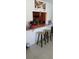 Kitchen counter and bar stools looking into kitchen with stainless steel faucet and hanging art at 3013 Yarmouth W Dr, Bradenton, FL 34205