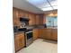Well-lit kitchen with wood cabinets and modern stainless steel appliances at 3013 Yarmouth W Dr, Bradenton, FL 34205
