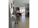 A casual living area with a kitchen bar and stools, looking towards screened outdoor area at 3013 Yarmouth W Dr, Bradenton, FL 34205