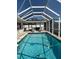 Beautiful view of the screened-in pool with a safety hose and attached lounge chairs to relax at 3013 Yarmouth W Dr, Bradenton, FL 34205