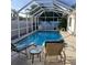 Relaxing screened-in pool with lounge chairs and blue water, surrounded by lush greenery at 3013 Yarmouth W Dr, Bradenton, FL 34205
