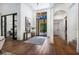 Grand foyer with a decorative light fixture, hardwood floors, and a large window offering natural light at 329 Bird Key Dr, Sarasota, FL 34236