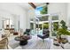 Bright living room with beamed ceilings, white walls, and views of the pool area at 329 Bird Key Dr, Sarasota, FL 34236
